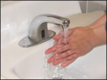 Wet hands under faucet