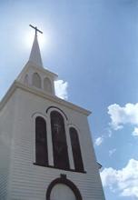 Photo of the Olde St. Ann's Church steeple taken from the shadow of the sun.