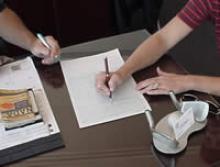 Filling out paperwork on a desktop.