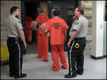 Inmates being let into the jail by correction officers.