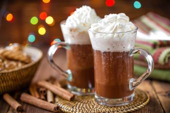 2 jugs of hot cocoa with whip cream
