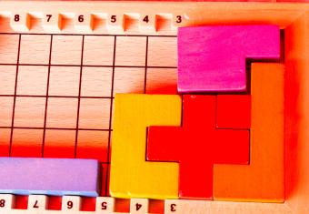 colorful wooden blocks on top of a wooden game board