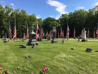 U.S. Flags adorn Allens Grove Cemetery, Scott County.