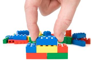 Hand playing with LEGO bricks