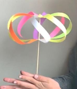 spin toy with colorful slips of paper and a stick