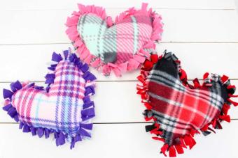 Heart shaped pillows in purple, pink, and red with fringe