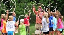 Campers playing with hula-hoops during an indian presentation.